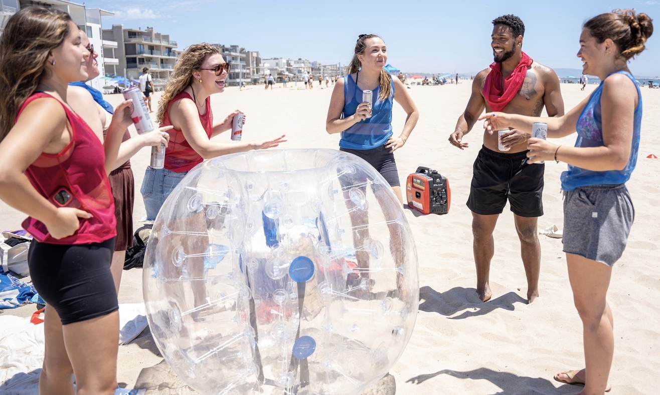 Teams playing bubble sports and party on Venice beach