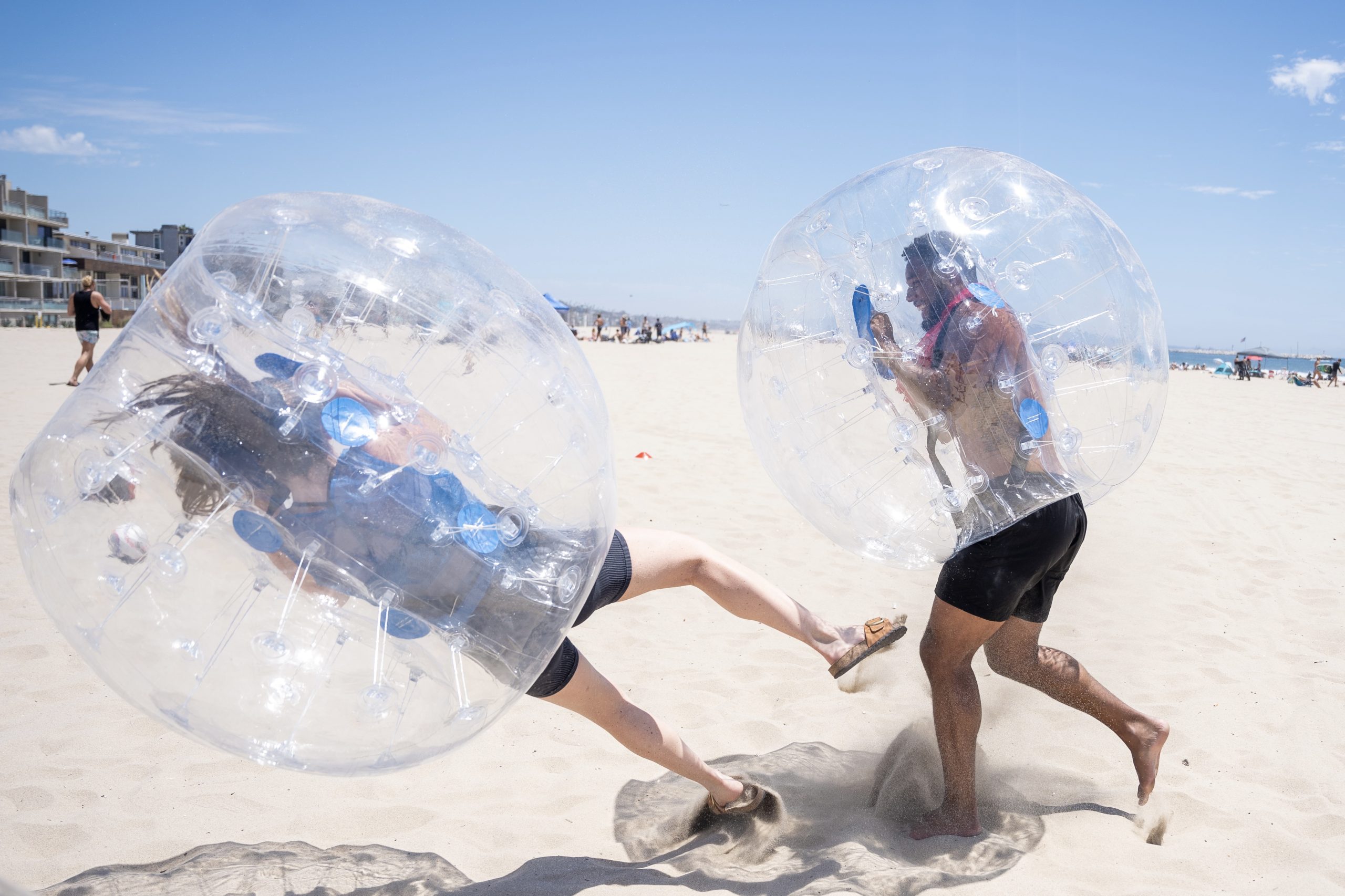 Playing in zorb, bubble balls on Venice beach compnay team building event