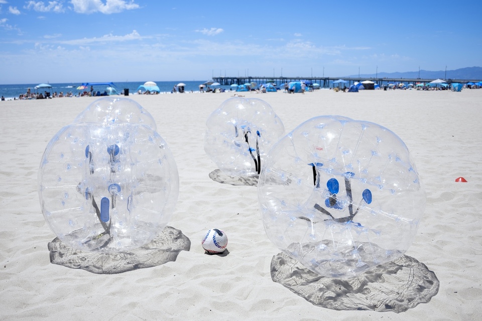 3v3 game of bubble soccer bubble suits on the venice pier beach