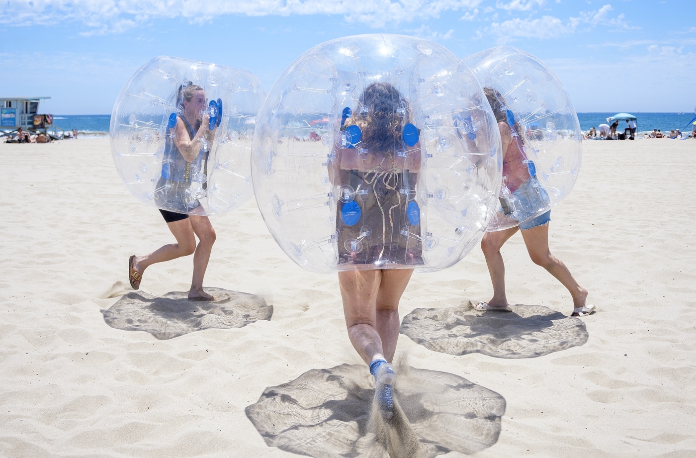 girls playing bubble sumo on beach at Venice Pier iin California at a birthday party