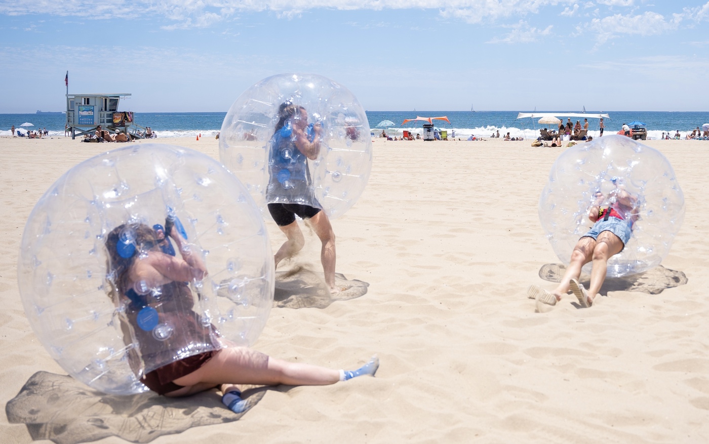 inflatable orbs and 3 girls bumping on the beach at Malibu